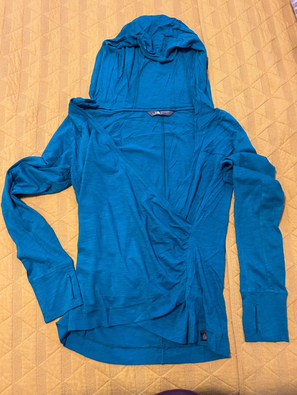 Women’s The North Face lightweight zip-up hoodie in a vibrant teal/blue color.